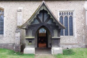 A church porch with open doors.